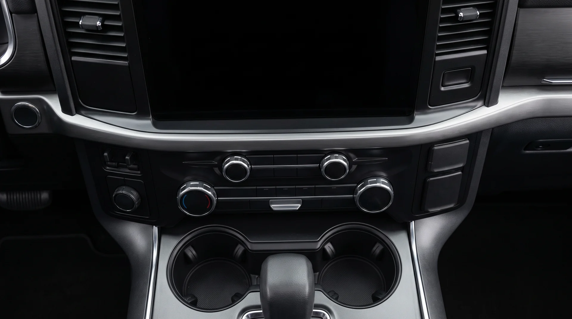 The same center console after detailing, the screen and vents dust free and the cupholders clean