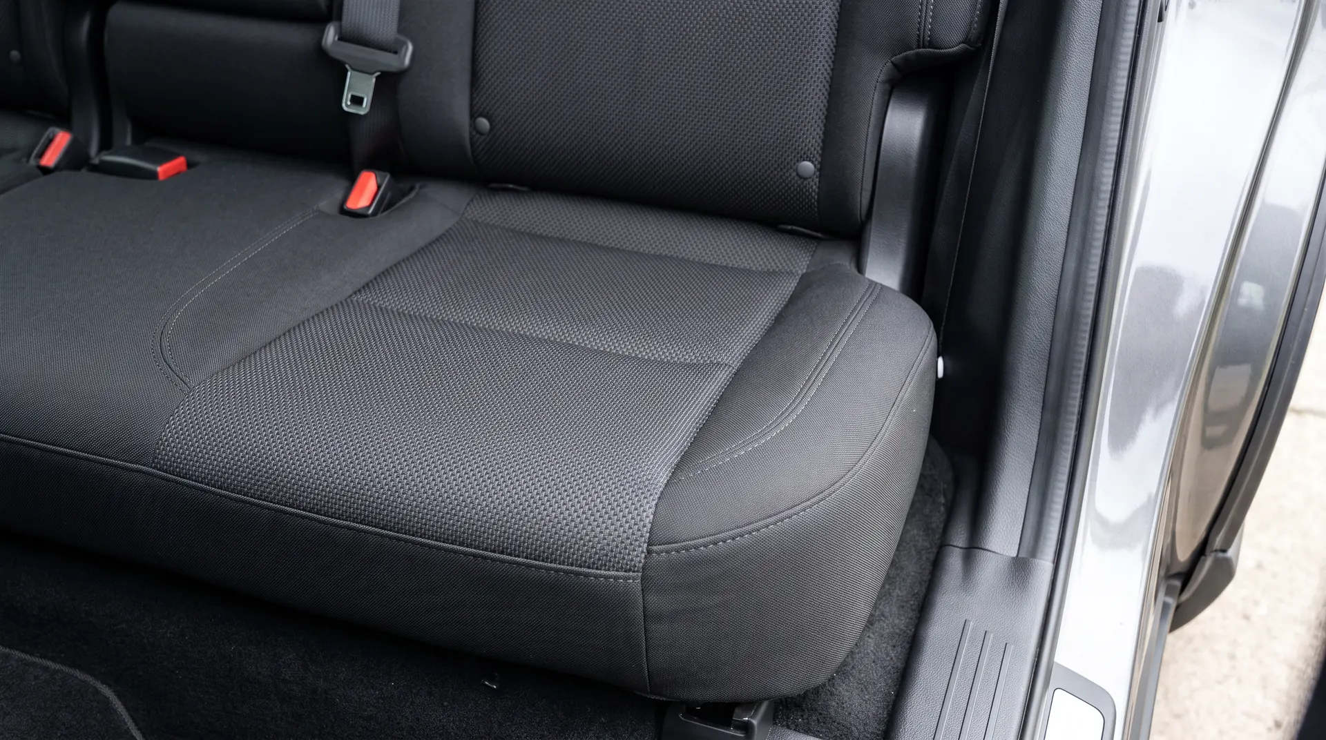 The same back seat after detailing, every strand of dog hair out of the cloth and the carpet vacuumed