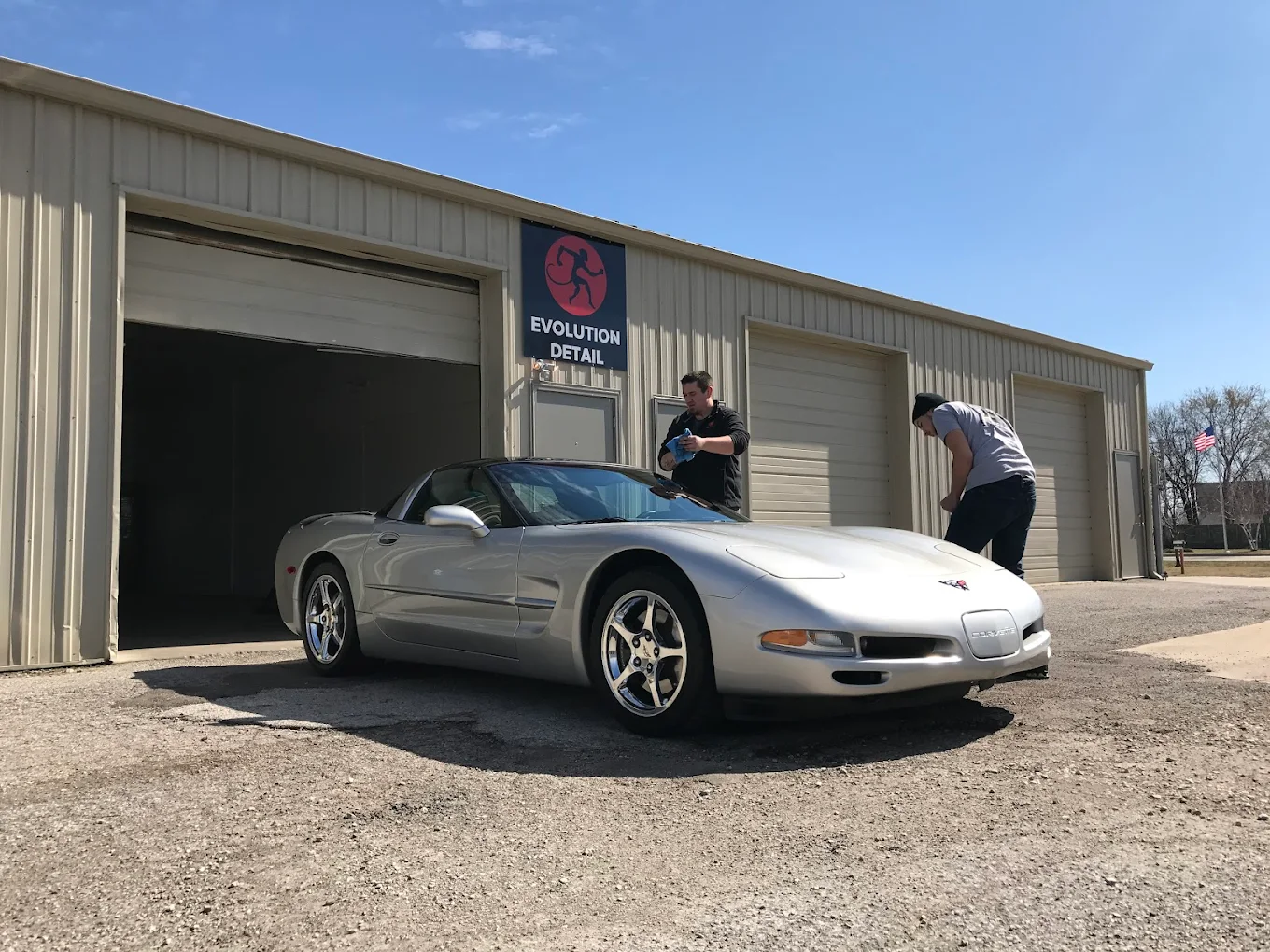 Silver C5 Corvette in front of the Evolution Detail shop