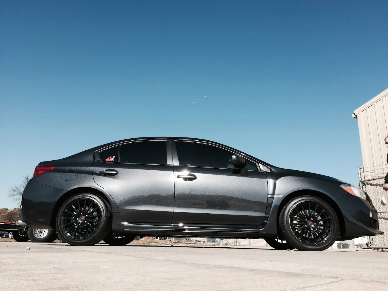 Dark gray Subaru WRX with glossy detailed paint shot from a low angle