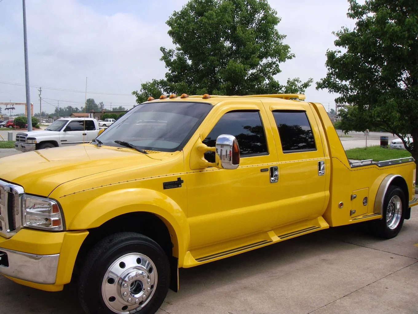 Bright yellow Ford F-450 custom hauler with a clean exterior