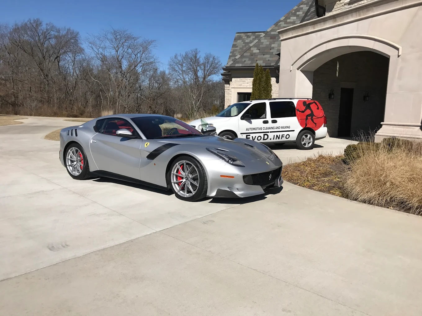 Silver Ferrari F12 detailed in a driveway with the Evolution Detail van behind it